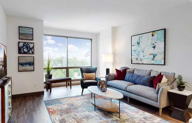 Enjoy the scenic views from the floor-to-ceiling windows in the living area of a 1 bedroom floor plan at Midtown Crossing Apartments Omaha