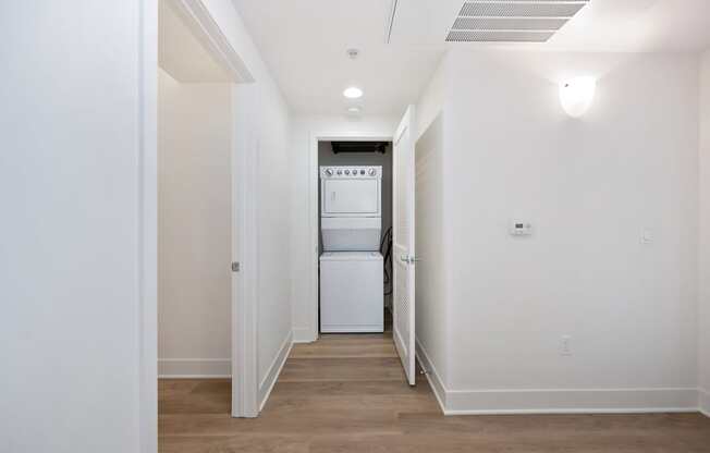 A white washer and dryer in a small laundry room.