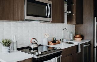 a kitchen with a stove top oven next to a sink