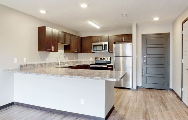 Renovated kitchen with large peninsula island with ample storage at Northridge Heights