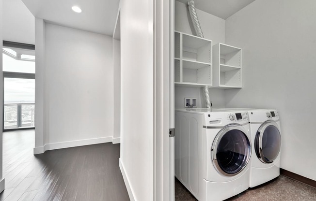Laundry rooms with front loading side-by-side washer and dryers at Cirrus, Seattle, Washington