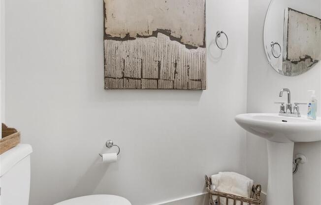 a bathroom with a sink toilet and a mirror