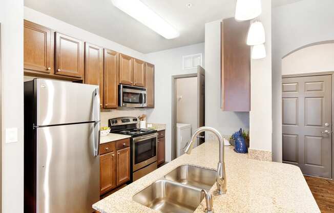 a kitchen with stainless steel appliances and granite counter tops