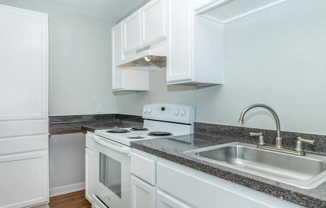 a kitchen with a stove and a sink