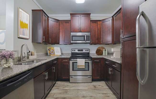 a kitchen with stainless steel appliances and wooden cabinets