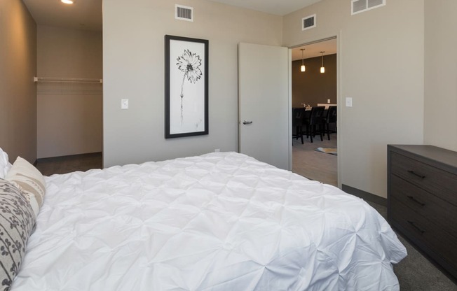 Bright, vacant bedroom with neutral walls and carpet flooring.