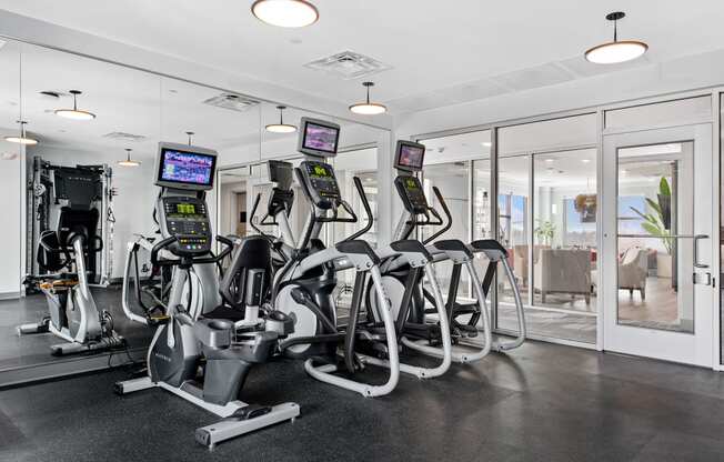 a row of exercise bikes in a gym