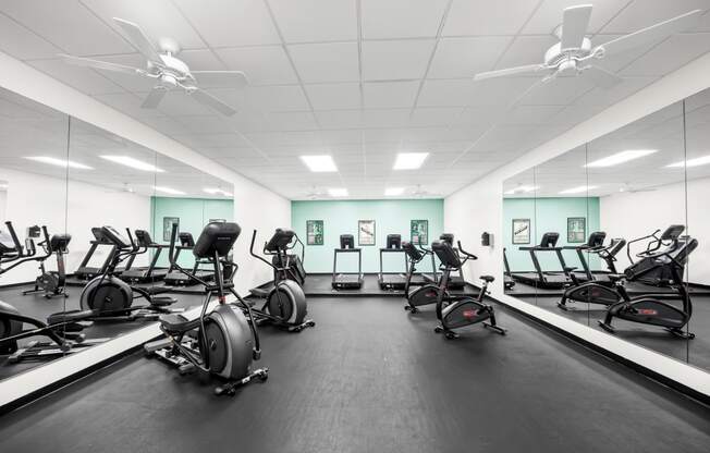 Large fitness room filled with exercise bikes at University Ridge Apartments, Durham, NC, 27707