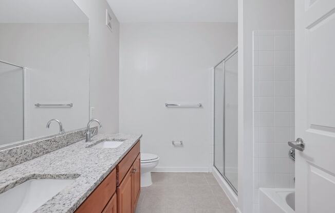 a bathroom with a sink and a shower and a toilet