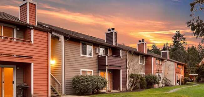 a row of houses with a sunset in the background at Quartz Creek, Mountlake Terrace, WA, 98043