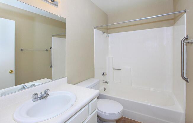 a large white tub sitting next to a sink