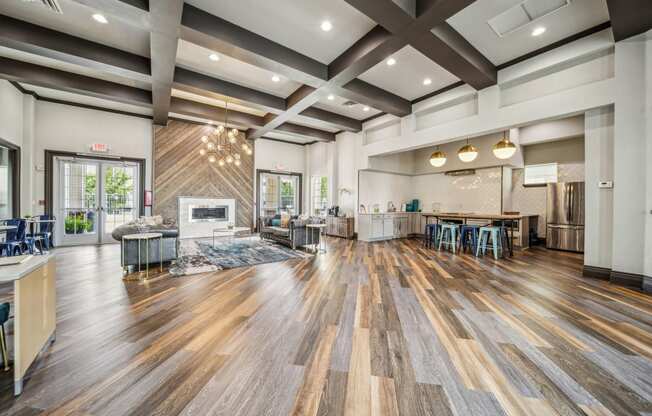 a large living room with a fireplace and a table with chairs