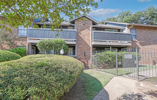 Apartment balconies and patios next to the pool gate with pool views at The Pearl apartments in Shreveport, LA