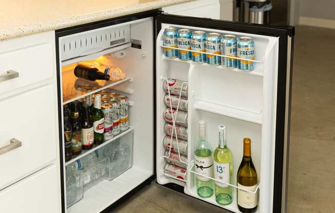 an open refrigerator in a kitchen with a counter top