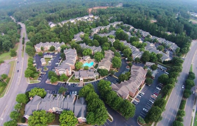 an aerial view of the resort properties surrounded by trees