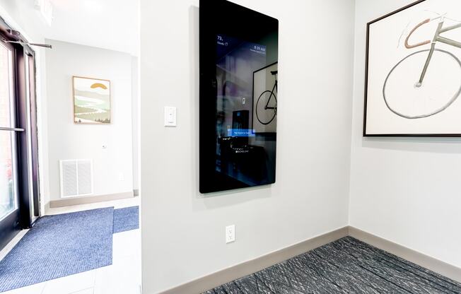 a room with a picture of a bike hanging on the wall