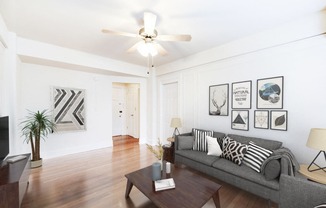 living area with sofa, coffee table, hardwood floors and ceiling fan at wakefield hall apartments in washington dc