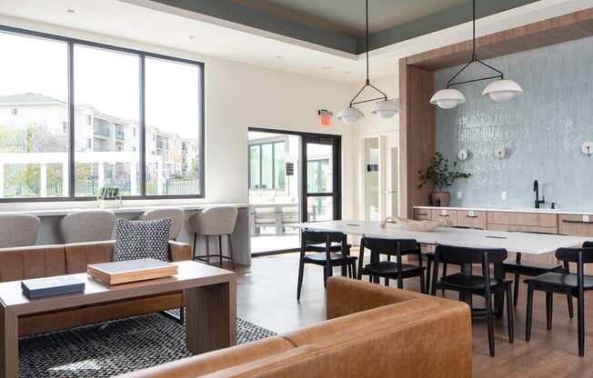 a dining room with tables and chairs and a large window