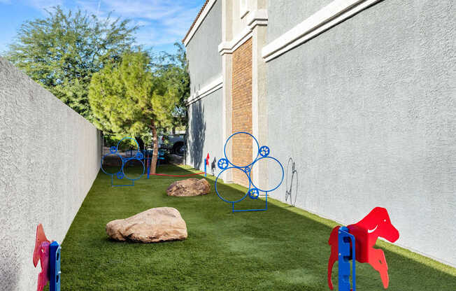 A playground with a red horse and a blue horse.