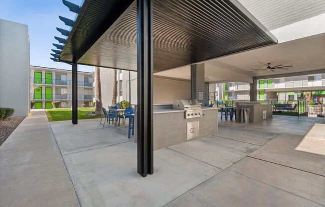 Covered outdoor kitchen space with BBQ grills