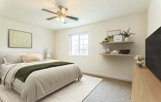 A bedroom with a bed, a ceiling fan, and a window.