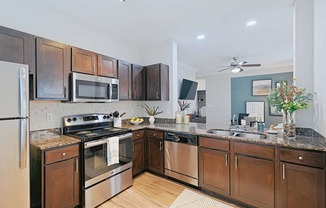 a kitchen with stainless steel appliances and wooden cabinets