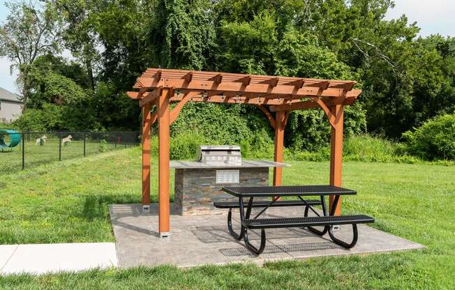 a picnic area with a picnic table and a fire pit