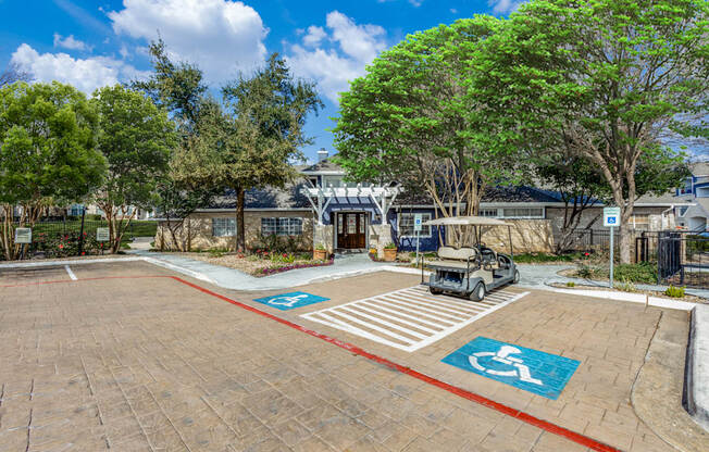 A parking lot with a car and a golf cart parked in the disabled parking spaces.