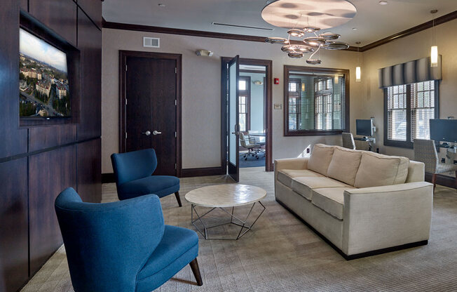 A living room with a blue chair and a white couch at Vermella Lyndhurst apartments, Lyndhurst, NJ, 07071