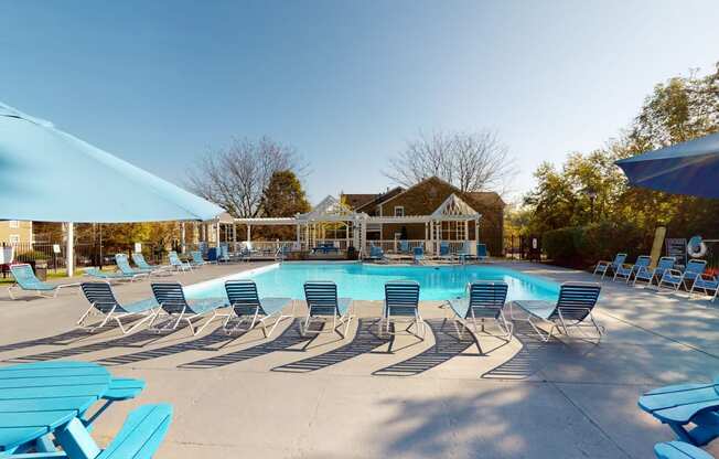 the resort style pool is surrounded by chairs and umbrellas