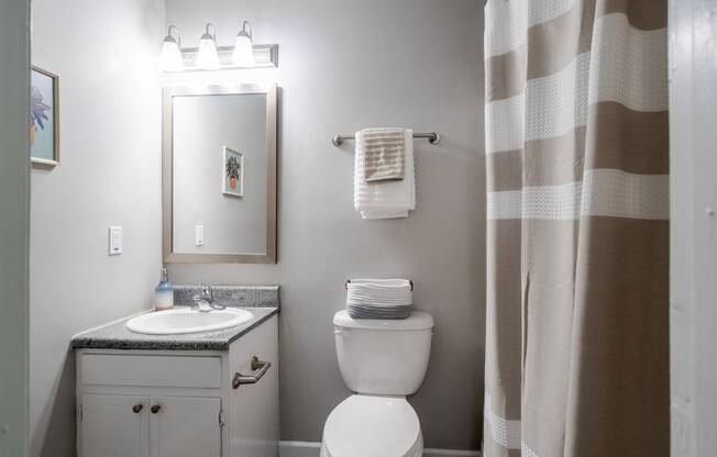 a small bathroom with a shower and a toilet and a sink