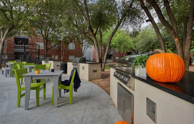 A pumpkin is sitting on a counter in a courtyard.