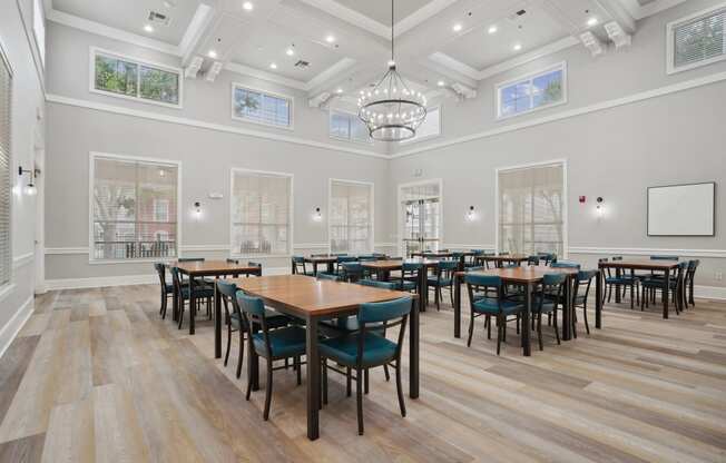 a large dining room with tables and chairs and windows