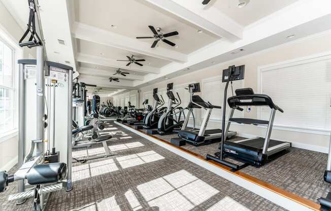 Premium fitness center with cardio equipment and weight machines at Riverstone apartments for rent in Macon, GA