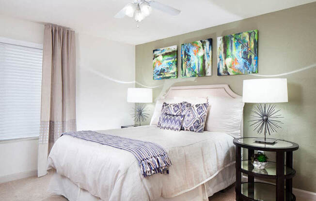 Ardenne Apartments bedroom with queen sized bed with white headboard and linen and one large window