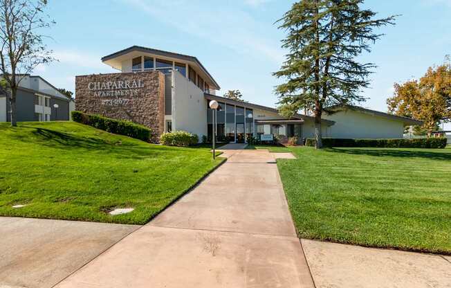A building with the sign Chaparral Apartments on it.
