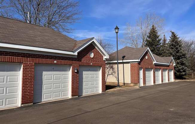 a row of three garage doors on a brick building