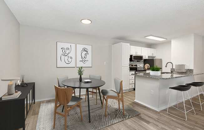 Model Dining Room with Wood-Style Flooring and View of Kitchen at Seven Lakes at Carrollwood Apartments in Tampa, FL.