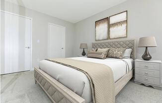 a bedroom with a bed and desk in a room