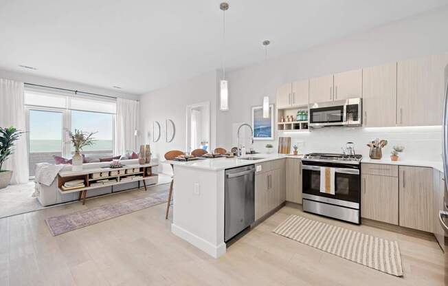 A modern kitchen with a dining area and a view of the beach.