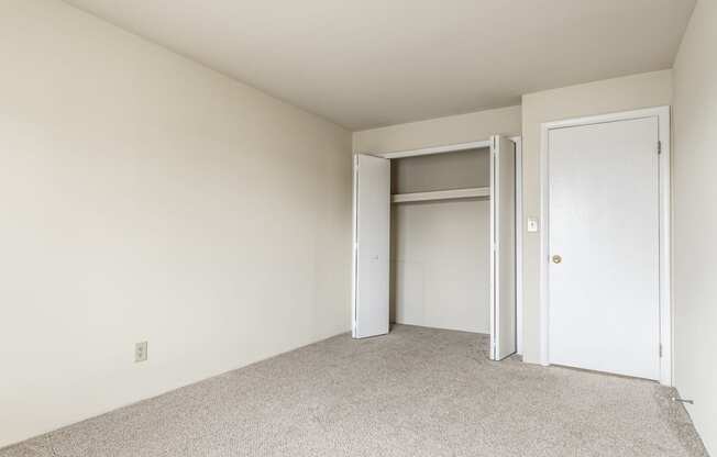 a bedroom with a closet and an open door