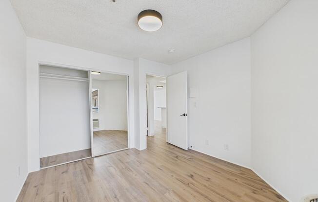 A room with white walls and wooden flooring.