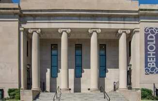 the front of a building with columns and stairs