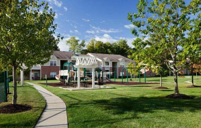 Community green lawn with trees and playground