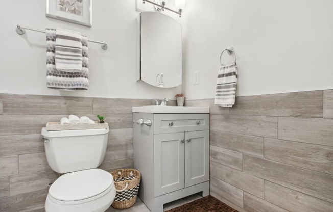 a white bathroom with a toilet and a sink