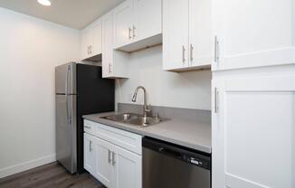 a kitchen with a stove and a refrigerator