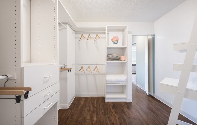 A white laundry room with a washer and dryer.