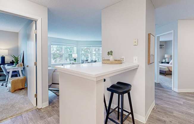 a kitchen with a counter top and a bar with two stools