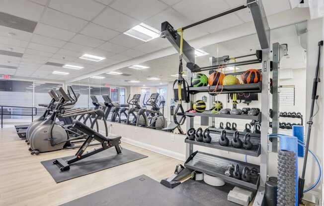 24/7 Fitness Center with Cardio Equipment, Free Weights, and Strength Training.