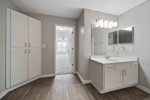 large bathroom with expansive mirror.